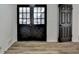 Inviting entryway featuring modern wood-look flooring and elegant black double doors at 4756 Fellsridge Dr, Stone Mountain, GA 30083