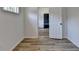 Hallway view featuring hardwood flooring, white walls, and a door leading to another room at 4756 Fellsridge Dr, Stone Mountain, GA 30083