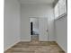 Hallway view featuring hardwood flooring, white walls, and a door leading to another room at 4756 Fellsridge Dr, Stone Mountain, GA 30083
