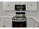 This kitchen is equipped with stainless steel appliances, white cabinets, and gold hardware at 4756 Fellsridge Dr, Stone Mountain, GA 30083
