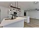 Kitchen with stainless appliances, white cabinets and countertops, and hardwood floors throughout open floor plan at 4756 Fellsridge Dr, Stone Mountain, GA 30083