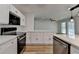 Kitchen featuring stainless steel appliances, white cabinetry, countertops, and hardwood floors at 4756 Fellsridge Dr, Stone Mountain, GA 30083