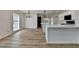 Open-concept kitchen and dining area featuring modern lighting and wood-look flooring at 4756 Fellsridge Dr, Stone Mountain, GA 30083