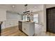 Open-concept kitchen and dining area featuring modern lighting and wood-look flooring at 4756 Fellsridge Dr, Stone Mountain, GA 30083