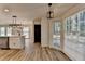 Kitchen with island sink, stainless appliances, white cabinets and countertops, and hardwood floors at 4756 Fellsridge Dr, Stone Mountain, GA 30083