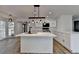 Open-concept kitchen and dining area featuring modern lighting and wood-look flooring at 4756 Fellsridge Dr, Stone Mountain, GA 30083