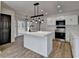 Bright kitchen features a central island, stainless steel appliances, wood flooring, and modern light fixtures at 4756 Fellsridge Dr, Stone Mountain, GA 30083