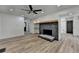 Open-concept living room boasts a stone fireplace, hard surface floors and neutral color palette at 4756 Fellsridge Dr, Stone Mountain, GA 30083