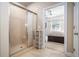 Bathroom with glass shower, tile walls, and view to bedroom with bed at 100 Marietta Walk Trce, Marietta, GA 30064
