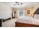 Bright bedroom featuring a plush bed, neutral carpet, and a bench by the window at 100 Marietta Walk Trce, Marietta, GA 30064