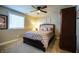 Cozy bedroom featuring a dark wood bed frame, carpet, and a window at 100 Marietta Walk Trce, Marietta, GA 30064
