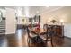 Elegant dining room with dark wood table, ornate chairs, and kitchen view at 100 Marietta Walk Trce, Marietta, GA 30064