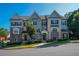 Charming townhome featuring stone accents, neutral colors, and a well-manicured lawn at 100 Marietta Walk Trce, Marietta, GA 30064