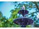 Elegant fountain surrounded by lush greenery and trees against a clear sky at 100 Marietta Walk Trce, Marietta, GA 30064