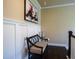 Stylish hallway with wainscoting, a decorative bench, and neutral paint at 100 Marietta Walk Trce, Marietta, GA 30064