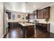 Modern kitchen featuring dark wood cabinets, granite countertops, and stainless steel appliances at 100 Marietta Walk Trce, Marietta, GA 30064