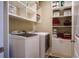 Laundry room with washer, dryer, white shelving and storage at 100 Marietta Walk Trce, Marietta, GA 30064