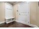 Bright mudroom featuring a built-in bench, coat hooks and storage, and a white door at 100 Marietta Walk Trce, Marietta, GA 30064