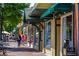 Charming storefronts along a brick-paved street, lined with shops, creating a welcoming and vibrant downtown shopping experience at 100 Marietta Walk Trce, Marietta, GA 30064