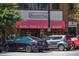 Classic soda pop and candy shop front with a vibrant red awning, inviting customers to indulge in sweet treats and nostalgic charm at 100 Marietta Walk Trce, Marietta, GA 30064