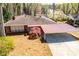Brick home with a carport, surrounded by a well-maintained yard and mature trees at 1181 Angelia Sw Dr, Mableton, GA 30126
