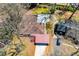 An aerial view showing the house with a brown roof, covered patio, and surrounding green trees at 1181 Angelia Sw Dr, Mableton, GA 30126
