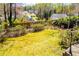 Spacious backyard with lush green grass, mature trees, and a charming vintage street lamp at 1181 Angelia Sw Dr, Mableton, GA 30126