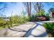 A nice view of a sidewalk with many trees and bushes growing in the backyard at 1181 Angelia Sw Dr, Mableton, GA 30126