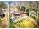 Backyard aerial view of a brick home with a patio and a well-maintained lawn and mature trees at 1181 Angelia Sw Dr, Mableton, GA 30126
