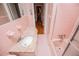 Pink bathroom featuring a tiled shower and granite countertop at 1181 Angelia Sw Dr, Mableton, GA 30126