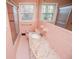 Bright pink bathroom with tiled walls and glass-enclosed shower at 1181 Angelia Sw Dr, Mableton, GA 30126