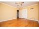 Bedroom with hardwood floors features neutral paint and closet door at 1181 Angelia Sw Dr, Mableton, GA 30126