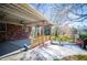 View of the covered patio with metal roof, ceiling fans, brick walls, and a decorative lion statue at 1181 Angelia Sw Dr, Mableton, GA 30126