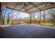 The spacious covered patio with wood railing has many trees for shade at 1181 Angelia Sw Dr, Mableton, GA 30126