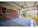 Spacious covered patio featuring ceiling fans, concrete flooring, and brick walls at 1181 Angelia Sw Dr, Mableton, GA 30126