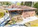 Charming brick home with a covered patio, wooden railing, mature trees, and a fenced yard at 1181 Angelia Sw Dr, Mableton, GA 30126