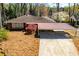 Well-maintained brick home with a covered carport and landscaped front yard featuring a red maple tree at 1181 Angelia Sw Dr, Mableton, GA 30126