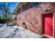 Charming brick home with a red door and spacious patio, perfect for outdoor gatherings at 1181 Angelia Sw Dr, Mableton, GA 30126
