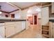 Bright kitchen with white cabinetry, granite countertops and view to a connecting living space at 1181 Angelia Sw Dr, Mableton, GA 30126