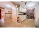 Bright kitchen featuring white cabinetry, brick accent wall, and view of connected spaces at 1181 Angelia Sw Dr, Mableton, GA 30126
