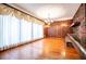 Warm living room featuring hardwood floors, brick accents, and custom drapery at 1181 Angelia Sw Dr, Mableton, GA 30126