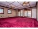 Expansive living room featuring plush carpet, multiple windows, and elegant ceiling fans at 1181 Angelia Sw Dr, Mableton, GA 30126
