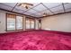 Expansive living room featuring plush carpet, multiple windows, and elegant ceiling fans at 1181 Angelia Sw Dr, Mableton, GA 30126