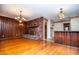 Spacious living room featuring hardwood floors, brick fireplace and view of the connected kitchen at 1181 Angelia Sw Dr, Mableton, GA 30126