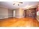 Inviting living room featuring hardwood floors, brick accent wall, and ample natural light at 1181 Angelia Sw Dr, Mableton, GA 30126