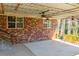 Covered patio featuring a brick wall, multiple fans, and wood railing at 1181 Angelia Sw Dr, Mableton, GA 30126