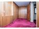 Cozy room with wood paneling and plush magenta carpet at 1181 Angelia Sw Dr, Mableton, GA 30126