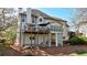 Back exterior view featuring a deck, a covered porch, and lush landscaping offers scenic relaxation at 1562 Asheforde Dr, Marietta, GA 30068