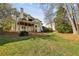 Spacious backyard featuring a well-maintained lawn, mature trees, and a multi-level deck offers great outdoor living at 1562 Asheforde Dr, Marietta, GA 30068