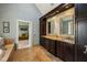 Bright bathroom with granite countertops, double sinks, and dark wood cabinetry at 1562 Asheforde Dr, Marietta, GA 30068